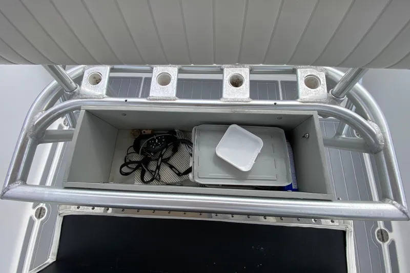 Slide: The Image of Storage compartment on a 2004 Palmetto 22 Excursion boat with fishing rod holders. - 49