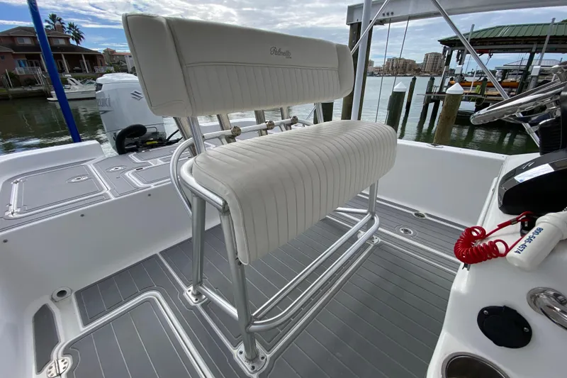 Slide: The Image of 2004 Palmetto 22 Excursion boat interior with white seating and gray flooring. - 50