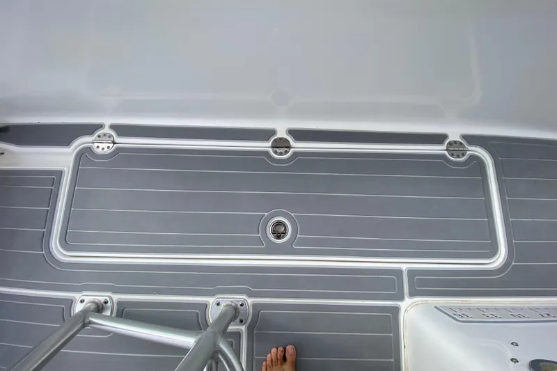 Slide: The Image of 2004 Palmetto 22 Excursion boat deck with gray non-slip surface and metal ladder. - 53