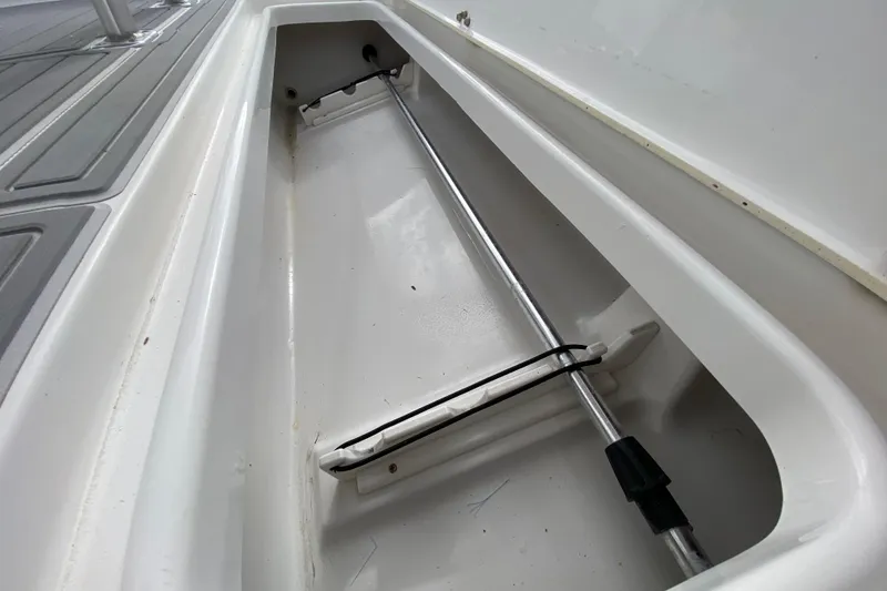 Slide: The Image of Storage compartment of a 2004 Palmetto 22 Excursion boat, featuring a hydraulic support rod. - 55