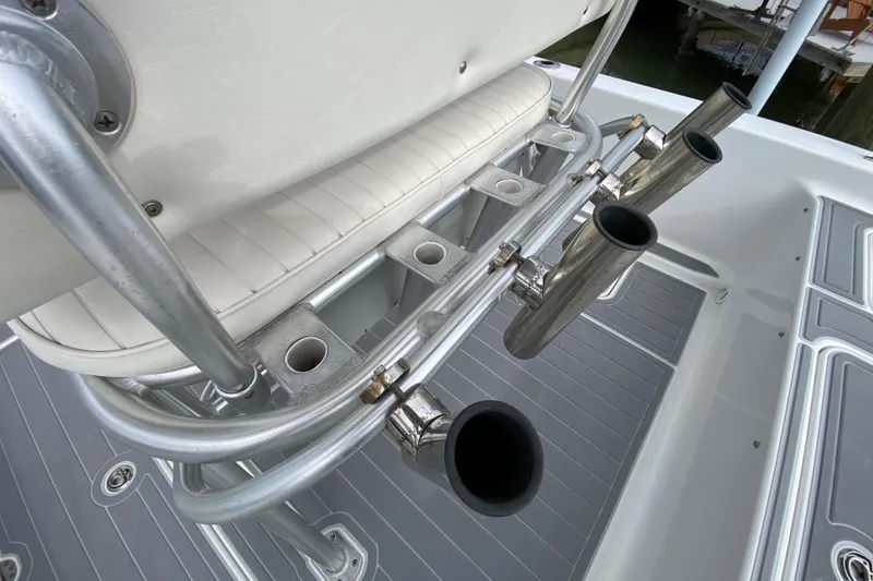 Slide: The Image of 2004 Palmetto 22 Excursion boat with rod holders and cushioned seating. - 57