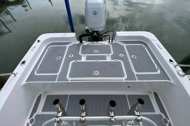 Slide: The Image of 2004 Palmetto 22 Excursion boat deck with Suzuki outboard motor, featuring multiple storage compartments. - 58