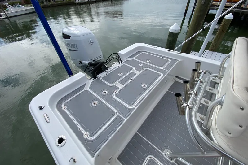 Slide: The Image of 2004 Palmetto 22 Excursion boat with Suzuki outboard motor, docked on calm water. - 60