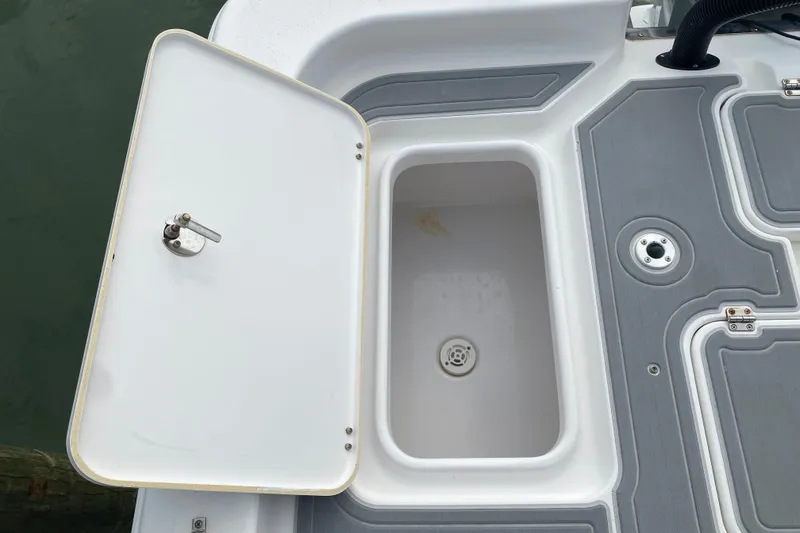 Slide: The Image of Open storage compartment on 2004 Palmetto 22 Excursion boat deck. - 63