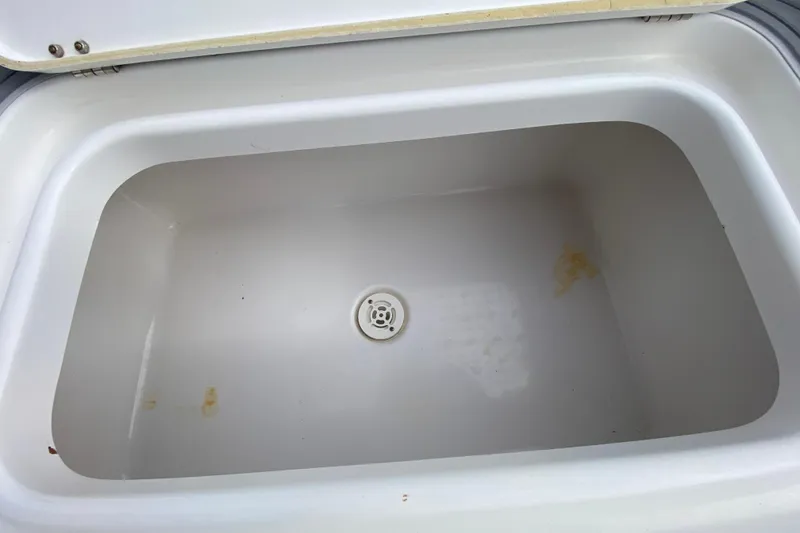 Slide: The Image of Open storage compartment in 2004 Palmetto 22 Excursion boat, featuring a clean interior. - 64