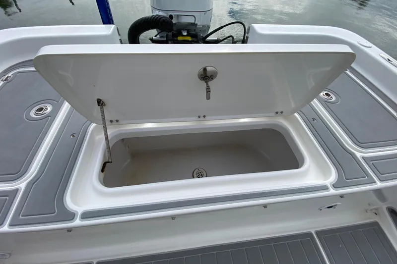 Slide: The Image of Open storage compartment on 2004 Palmetto 22 Excursion boat, showing interior details. - 66