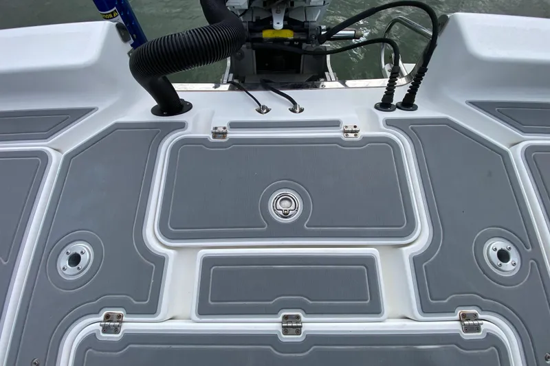 Slide: The Image of 2004 Palmetto 22 Excursion boat deck with storage compartments and engine connections. - 77