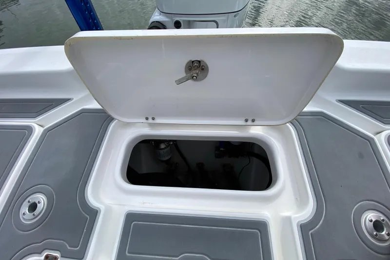 Slide: The Image of Open hatch on 2004 Palmetto 22 Excursion boat, revealing storage compartment. - 78