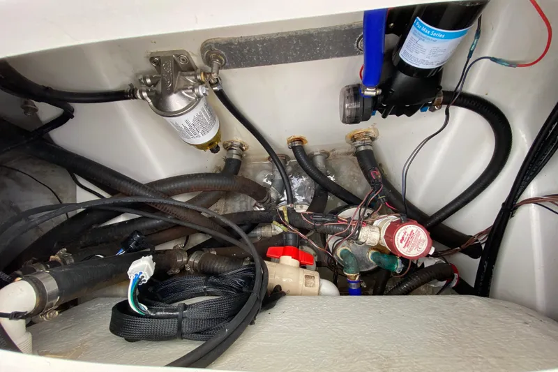 Slide: The Image of 2004 Palmetto 22 Excursion boat engine compartment with hoses and wiring. - 79