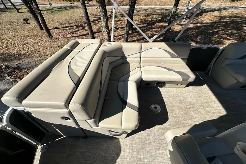 Slide: The Image of 2017 SunCatcher V18 Cruise boat interior with beige seating and carpeted floor. - 10