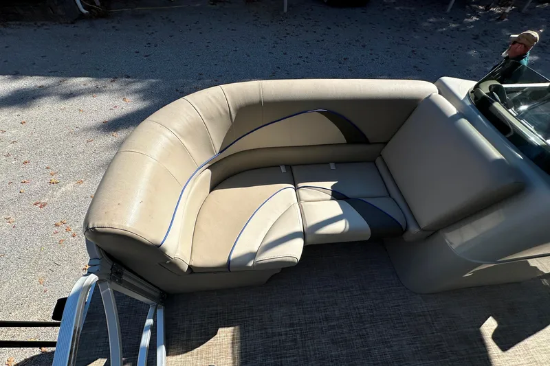 Slide: The Image of 2017 SunCatcher V18 Cruise boat interior with beige seating and blue accents. - 11