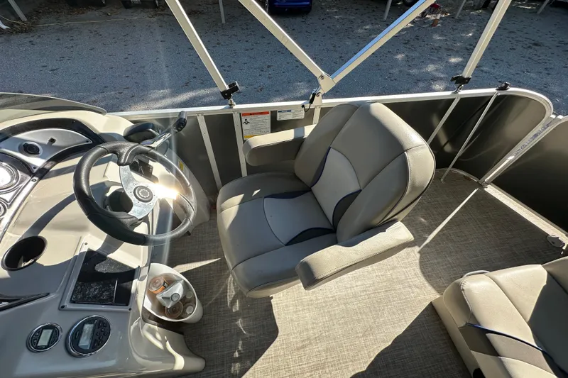 Slide: The Image of 2017 SunCatcher V18 Cruise boat interior with steering wheel and seating. - 17