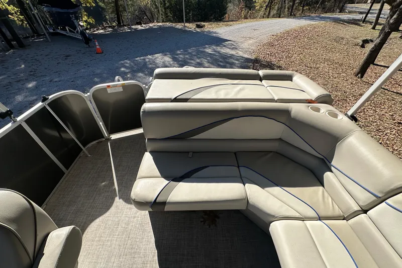 Slide: The Image of 2017 SunCatcher V18 Cruise boat interior with beige seating and cup holders. - 18