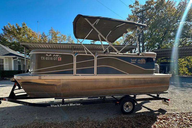 Slide: The Image of 2017 SunCatcher V18 Cruise pontoon boat on trailer, parked outdoors. - 4