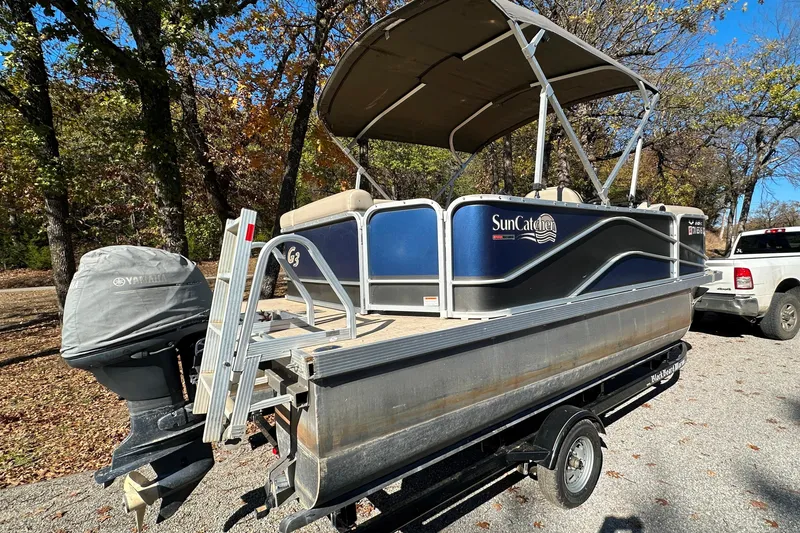 Slide: The Image of 2017 SunCatcher V18 Cruise pontoon boat on trailer, parked outdoors. - 7