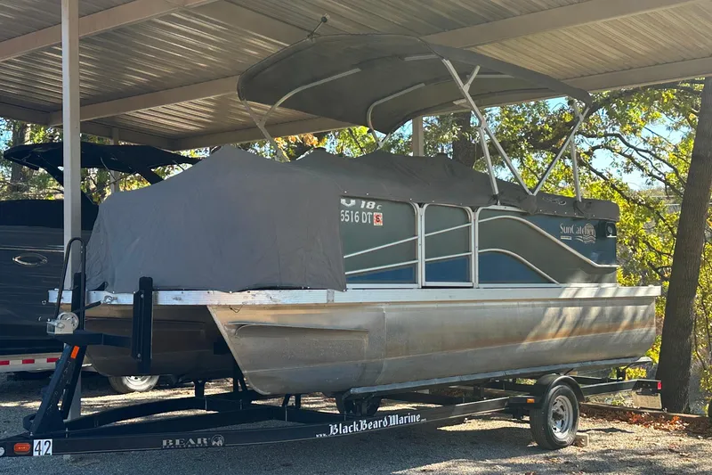 Slide: The Image of 2017 SunCatcher V18 Cruise pontoon boat covered and parked on a trailer. - 8