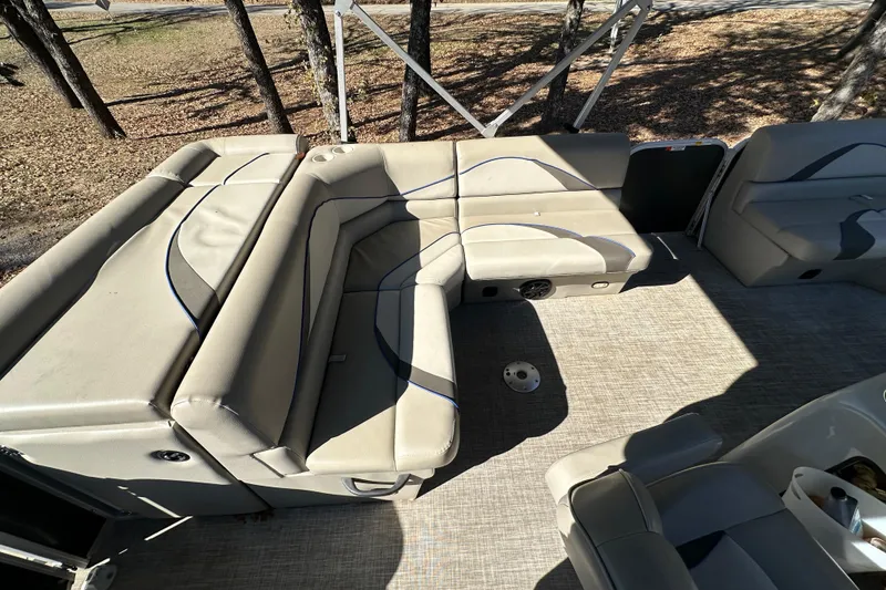 Slide: The Image of 2017 SunCatcher V18 Cruise boat interior with beige seating and spacious layout. - 9