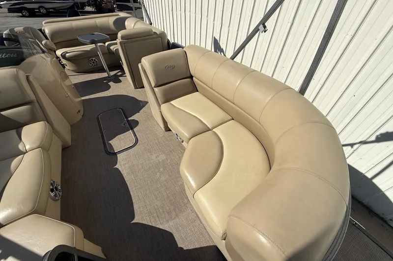 Slide: The Image of Luxurious beige seating on a 2017 Manitou 230 pontoon boat, showcasing spacious interior design. - 10