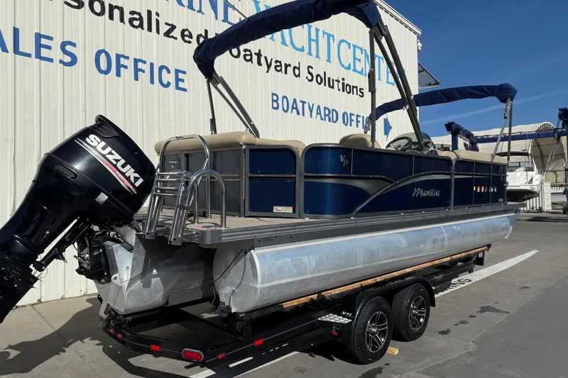 Slide: The Image of 2017 Manitou 230 pontoon boat with Suzuki outboard motor on trailer. - 7