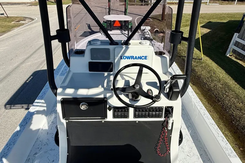 Slide: The Image of 2018 Shallow Sport 25 X3 boat console with steering wheel and Lowrance electronics. - 10