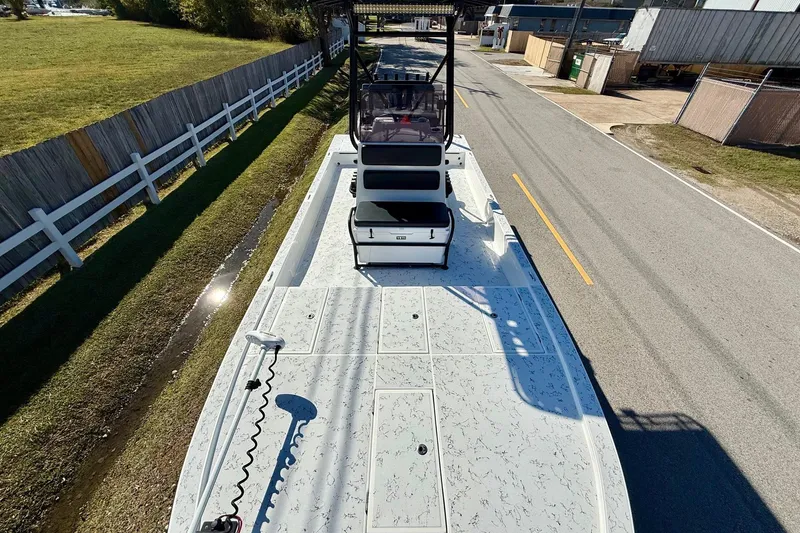 Slide: The Image of 2018 Shallow Sport 25 X3 boat on a trailer, parked on a roadside. - 15