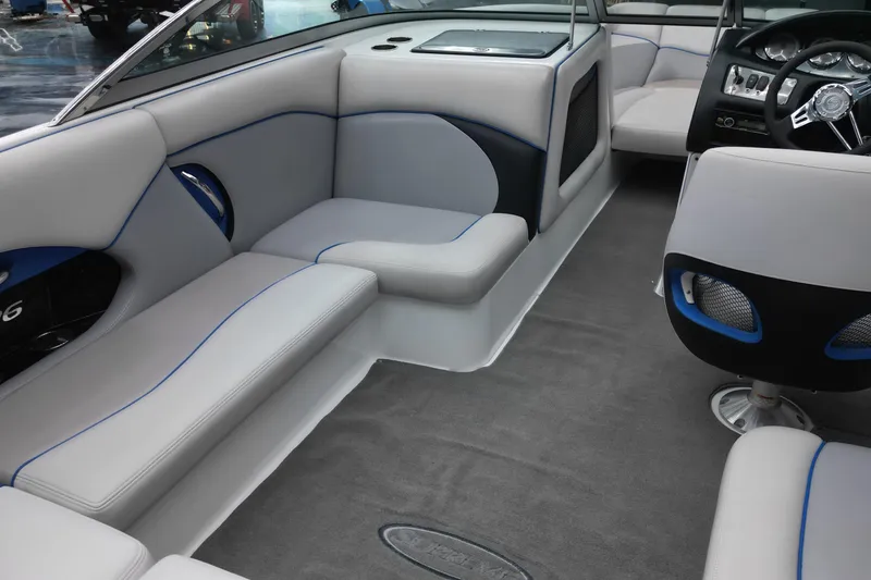 Slide: The Image of Interior of a 2012 Supreme V226 boat with gray seating and modern dashboard. - 10