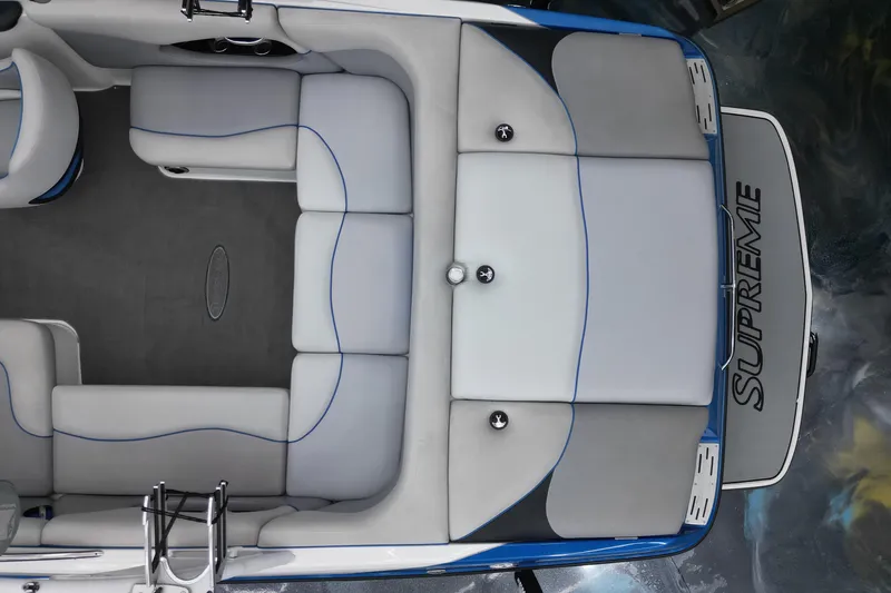 Slide: The Image of 2012 Supreme V226 boat interior with gray and blue seating, viewed from above. - 11