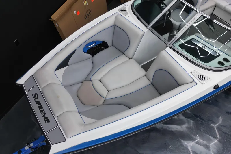 Slide: The Image of 2012 Supreme V226 boat interior with gray and blue seating, sleek design. - 6