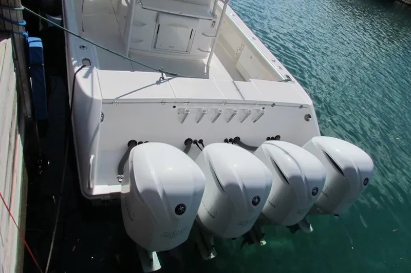 Slide: The Image of 2016 Everglades 435 Center Console boat with four powerful outboard engines. - 10