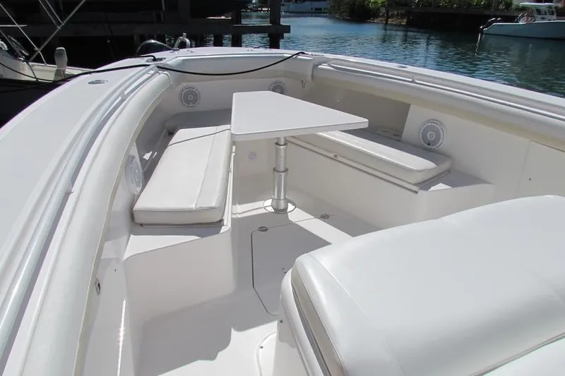 Slide: The Image of 2016 Everglades 435 Center Console boat interior with seating and table. - 13