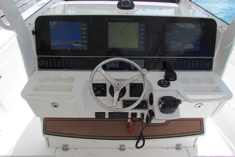 Slide: The Image of 2016 Everglades 435 Center Console helm with navigation screens and controls. - 17