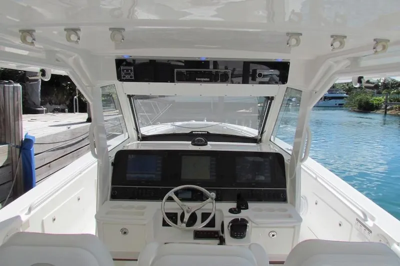 Slide: The Image of 2016 Everglades 435 Center Console boat cockpit with steering wheel and navigation displays. - 18