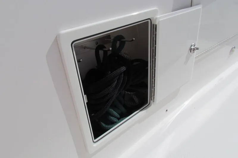Slide: The Image of Storage compartment with ropes on a 2016 Everglades 435 Center Console boat. - 25