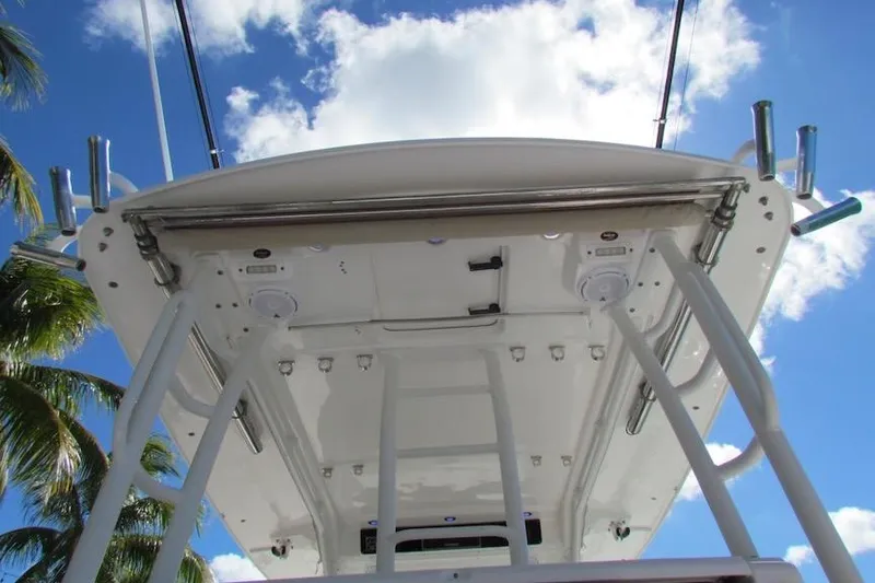 Slide: The Image of 2016 Everglades 435 Center Console boat, viewed from below against a blue sky. - 27
