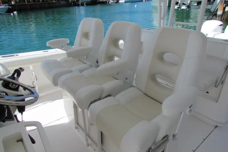 Slide: The Image of Luxury seating on 2016 Everglades 435 Center Console boat, featuring plush white chairs. - 29
