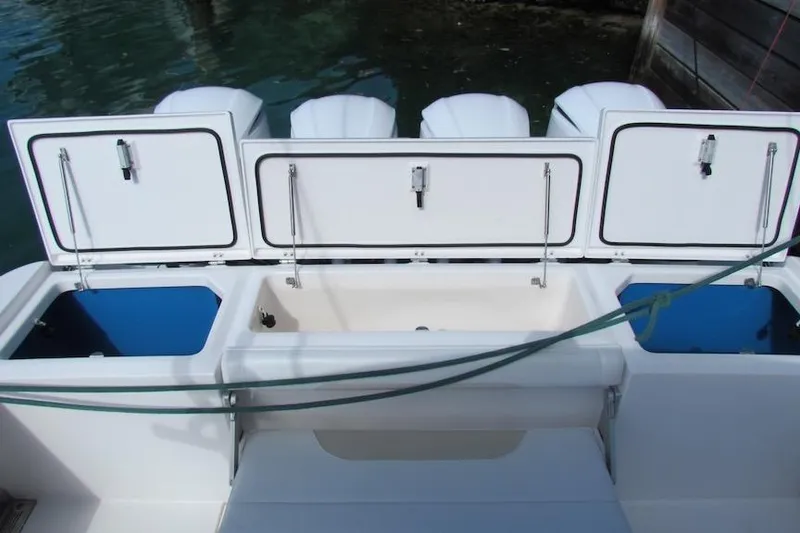 Slide: The Image of 2016 Everglades 435 Center Console boat with open storage compartments. - 30