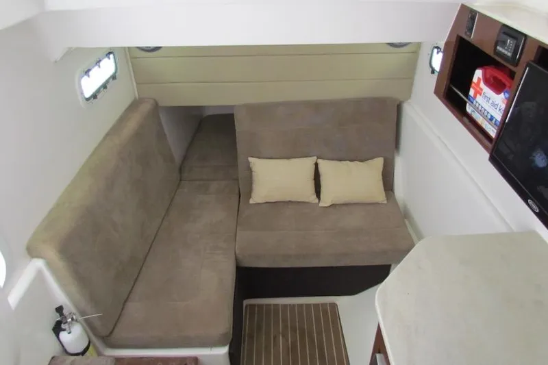 Slide: The Image of Interior cabin of 2016 Everglades 435 Center Console with beige seating and cushions. - 33