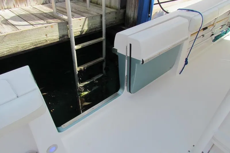 Slide: The Image of 2016 Everglades 435 Center Console boat with open side door and dock ladder. - 39