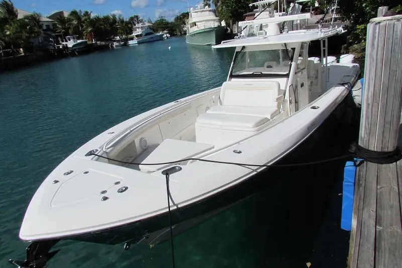 Slide: The Image of 2016 Everglades 435 Center Console boat docked in a scenic marina. - 5