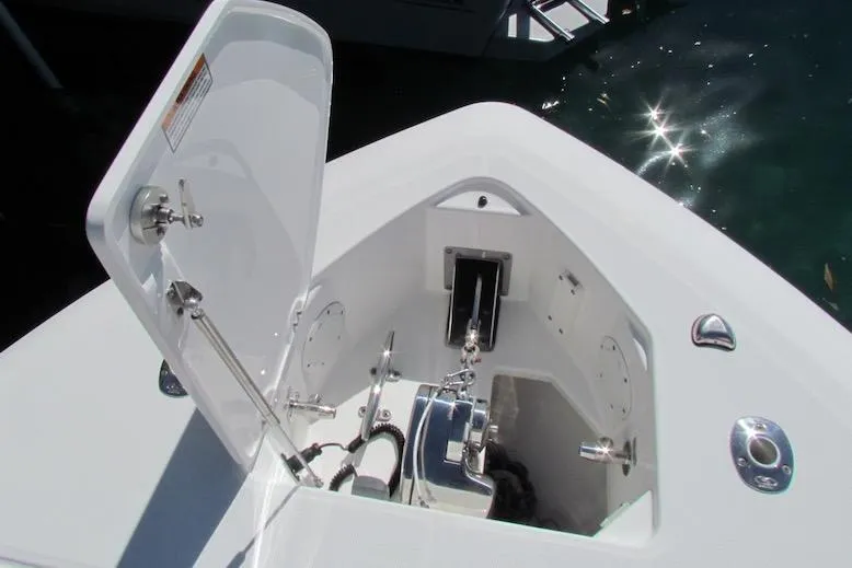 Slide: The Image of 2016 Everglades 435 Center Console anchor compartment with open hatch, docked on water. - 7