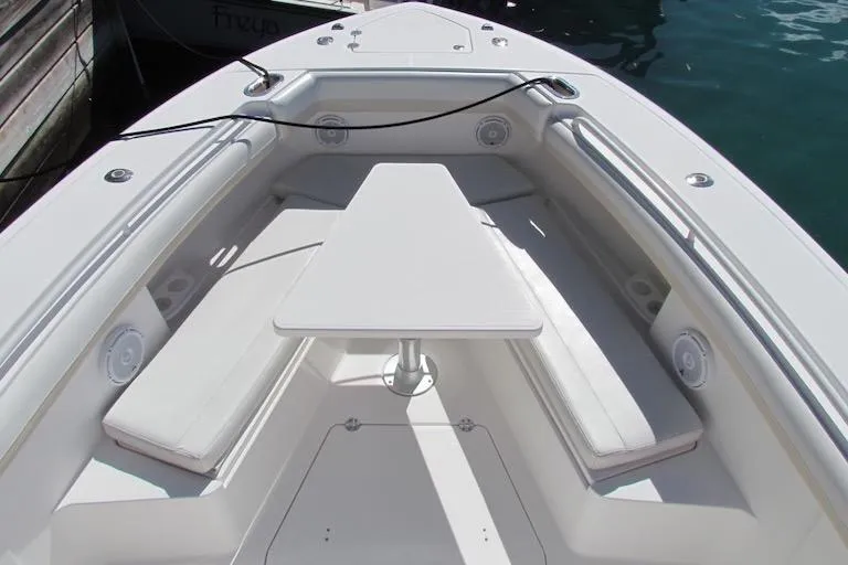 Slide: The Image of 2016 Everglades 435 Center Console boat with spacious seating and table in the bow area. - 8