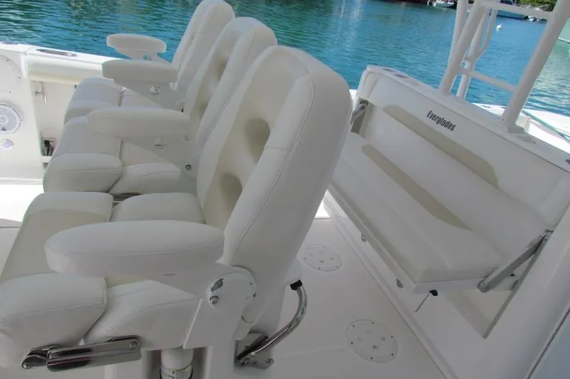 Slide: The Image of Luxury seating on 2016 Everglades 435 Center Console boat, with white leather chairs. - 9
