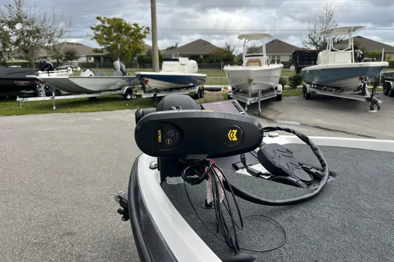 Slide: The Image of 2026 Skeeter ZXR21 SE boat with trolling motor in a parking lot. - 11