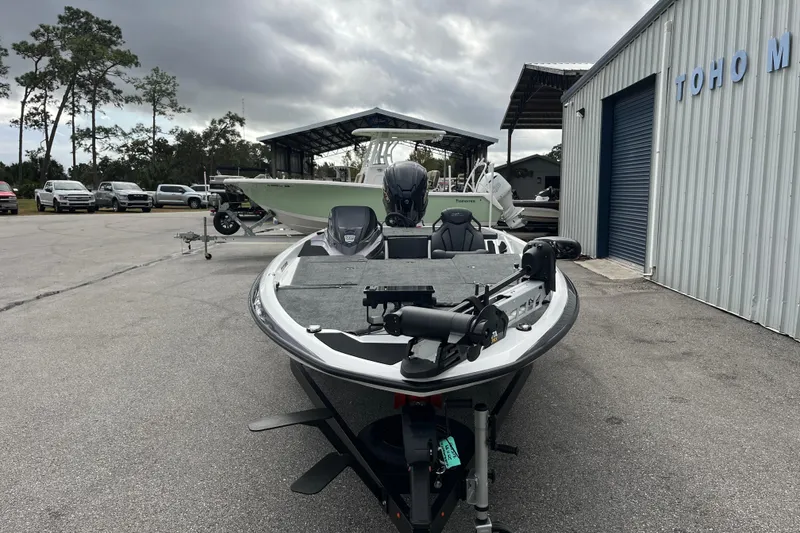 Slide: The Image of 2026 Skeeter ZXR21 SE boat parked outside dealership under cloudy sky. - 4