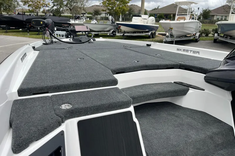 Slide: The Image of 2026 Skeeter ZXR21 SE boat deck with gray carpeting and modern design. - 6