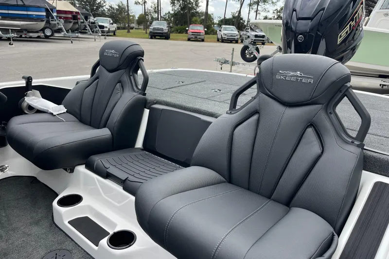 Slide: The Image of 2026 Skeeter ZXR21 SE boat interior with sleek, modern seating and cup holders. - 7