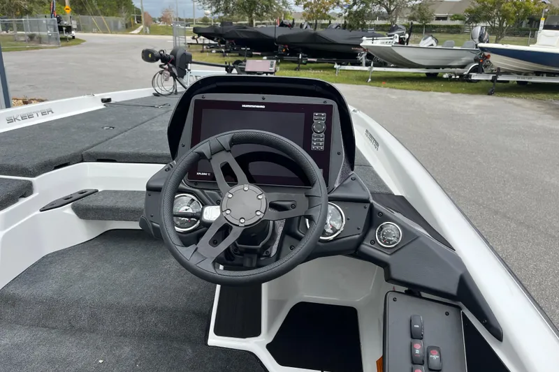 Slide: The Image of 2026 Skeeter ZXR21 SE boat cockpit with steering wheel and navigation display. - 8