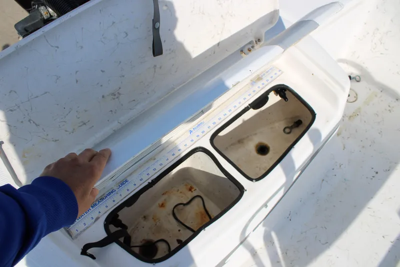 Slide: The Image of 2011 Blue Wave 2200 STL boat storage compartments with measuring guide. - 10