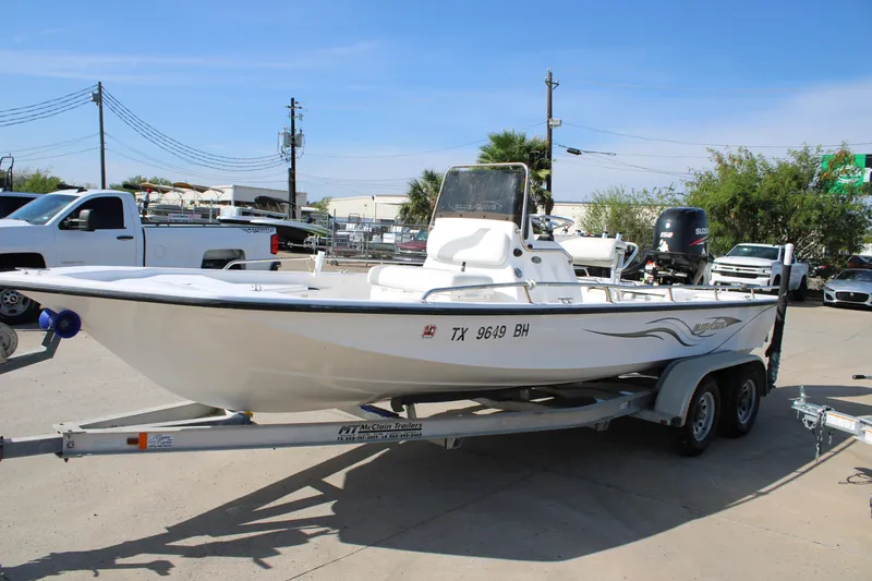 Slide: The Image of 2011 Blue Wave 2200 STL boat on trailer in parking lot. - 13