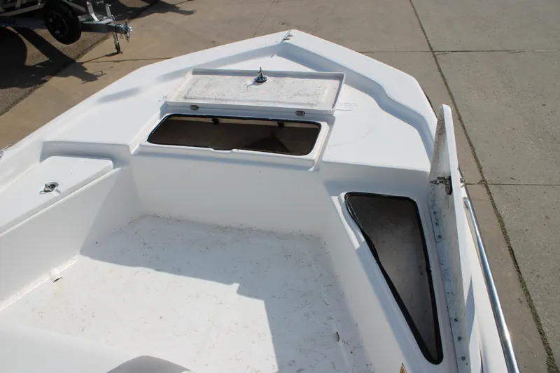 Slide: The Image of 2011 Blue Wave 2200 STL boat deck with open storage compartments. - 15